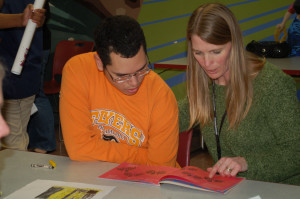 A Woods teacher reads a story to a Woods student.
