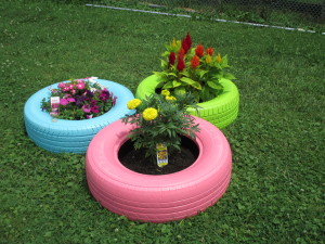 Painted tires hold a garden at Woods Services.