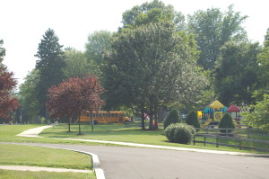 A school bus and playground on the campus of Woods Services.